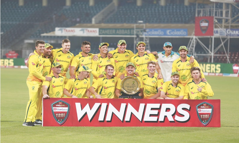 LAHORE: Australian players celebrate with the winners trophy after beating Pakistan in the solitary Twenty20 International at the Gaddafi Stadium.—Murtaza Ali/White Star