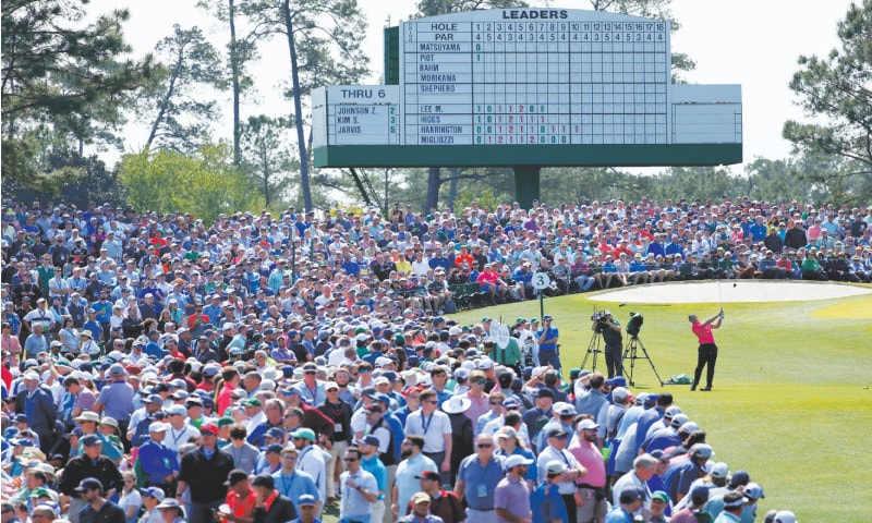 AUGUSTA: A general view as Tiger Woods of the US tees off on the third hole during the first round of the Masters at the Augusta National Golf Club on Thursday.—Reuters