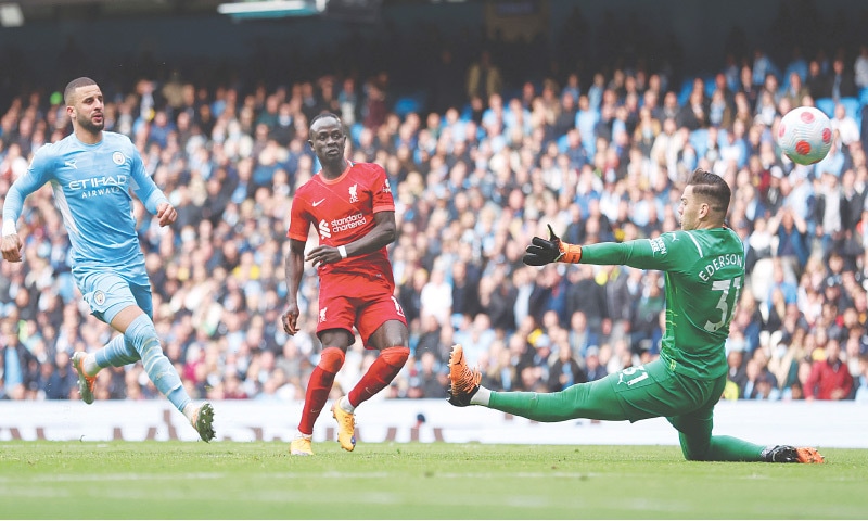 MANCHESTER: Liverpool&rsquo;s Sadio Mane (C) scores the equaliser past Manchester City goalkeeper Ederson at the Etihad Stadium on Sunday.&mdash; Reuters
