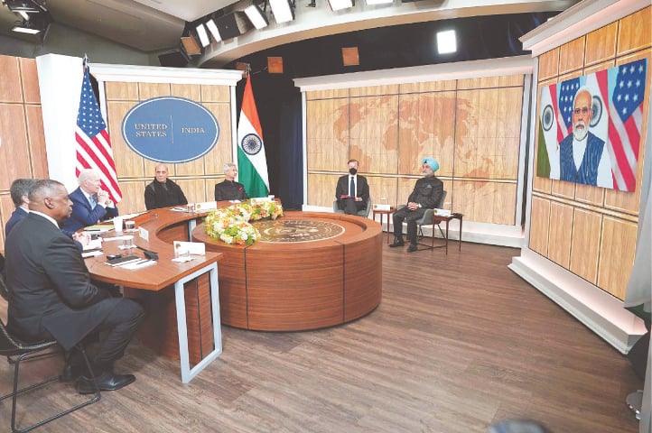 US President Joe Biden, alongside Defence Secretary Lloyd Austin (left) and Indian Defence Minister Rajnath Singh (fourth right), takes part in a virtual meeting with Indian Prime Minister Narendra Modi in the Eisenhower Executive Office Building, next to the White House.—AFP