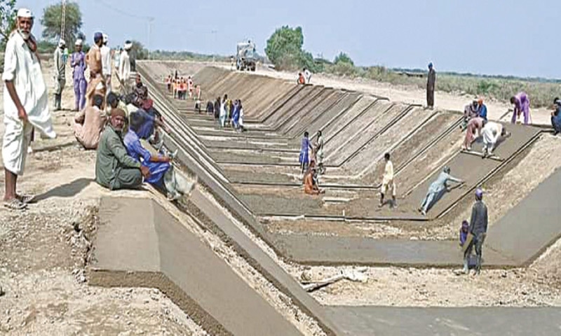LABOURERS busy working on the lining of the channel near Garho town on Wednesday.&mdash;Dawn