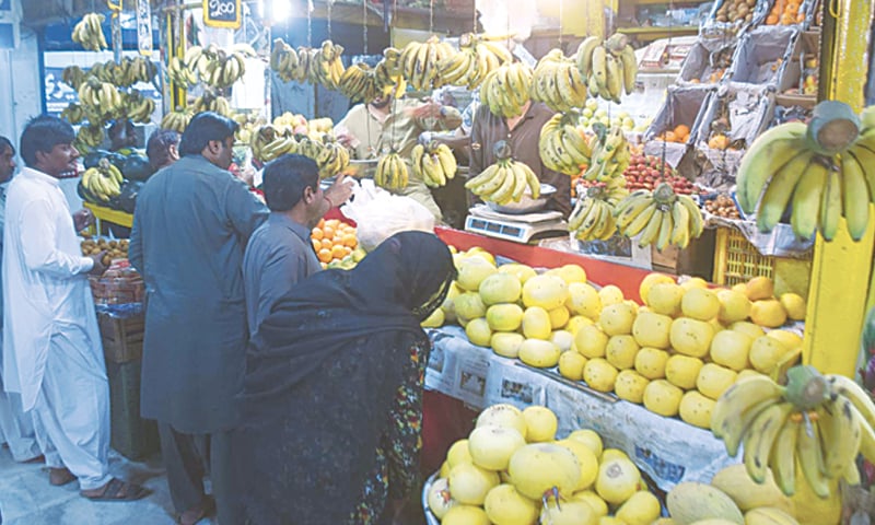 CUSTOMERS wait for their turn at a fruit stall in Hyderabad.&mdash;Dawn