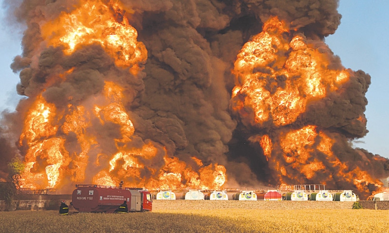 NOWSHERA: Firefighters try to battle a massive fire that broke out in an oil tanker terminal on Saturday. Police said one person was injured in the inferno, which also gutted at least 20 tankers.—AFP