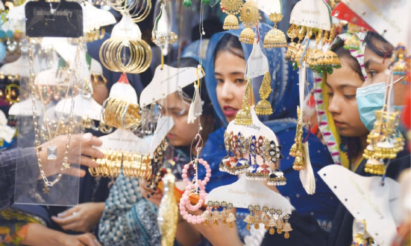 Women choose jewellery in Karachi ahead of Eid ul Fitr.—Online