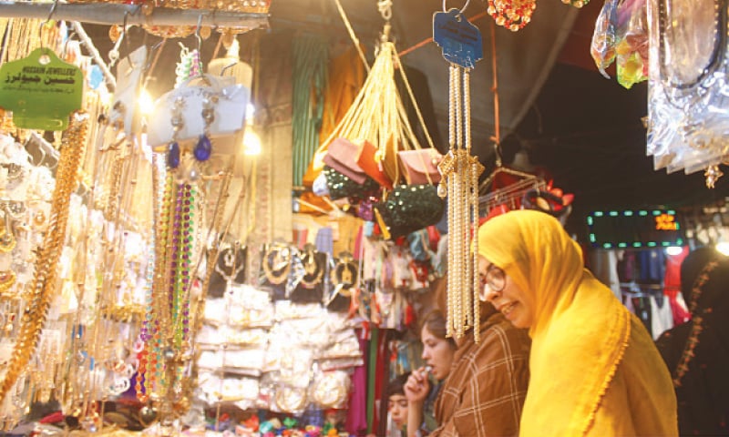 Women are buying jewellery from a vendor at Moti Bazaar in Rawalpindi for Eid.&mdash;Online