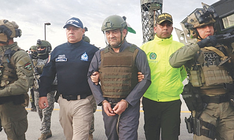 Colombian drug trafficker Dairo Antonio Usuga David, also known as  &ldquo;Otoniel&rdquo;, gets escorted by police officers after Colombia extradites him to the United States.&mdash;Reuters