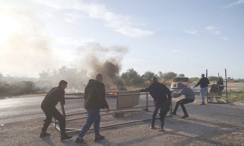 Silat al-Harithiya: Palestinian youths block a road following the demolition by Israeli security forces of a house in the village here on Saturday.&mdash;AFP