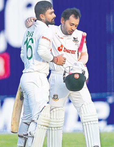 BANGLADESH batters Liton Das (L) and Mushfiqur Rahim walk off at the close of play on the first day of the second Test against Sri Lanka at the Sher-e-Bangla National Cricket Stadium.—AFP