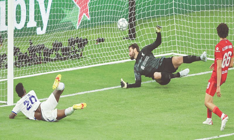 SAINT DENIS: Real Madrid’s Vinicius Junior (L) scores past Liverpool goalkeeper Alisson Becker during the Champions League final at Stade de France.—AFP SAINT DENIS: Real Madrid’s Vinicius Junior (L) scores past Liverpool goalkeeper Alisson Becker during the Champions League final at Stade de France.—AFP