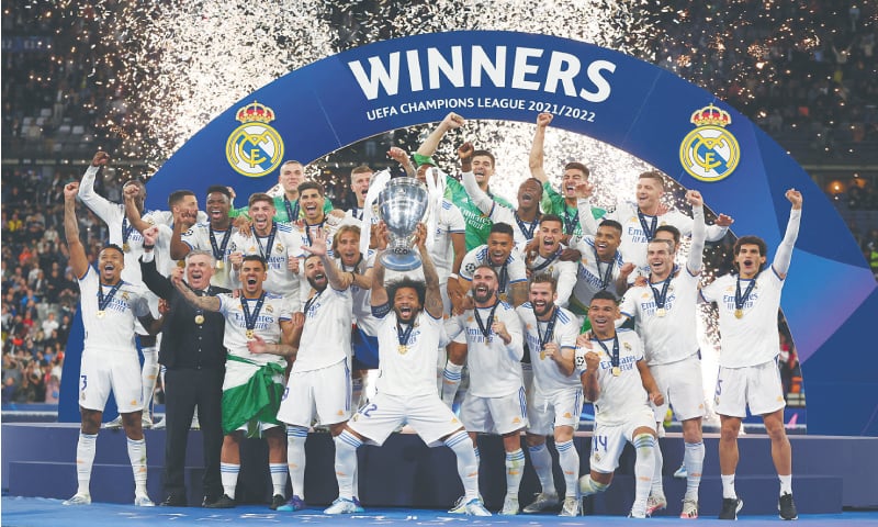 REAL Madrid’s Marcelo lifts the trophy as his team-mates celebrate after winning the final.—Reuters
