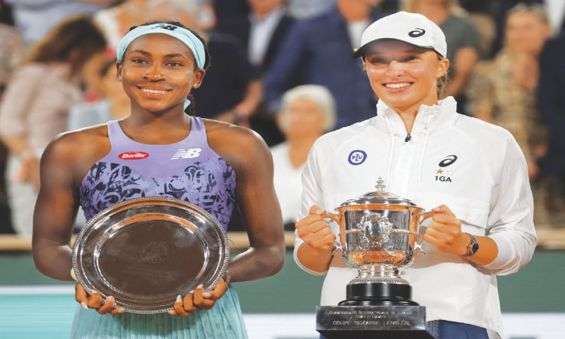 POLAND&rsquo;S Iga Swiatek (R) and Coco Gauff of the US pose with their trophies after the French Open final on Saturday.&mdash;Reuters