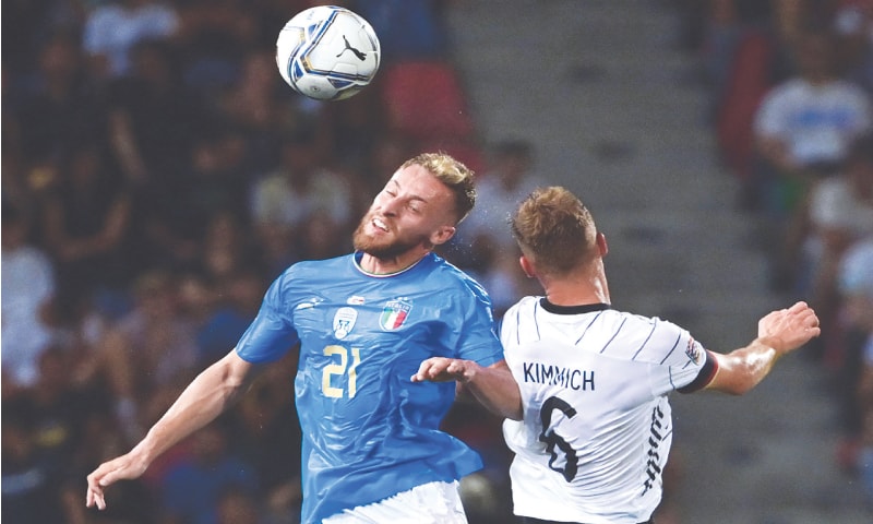 BOLOGNA: Italy’s Davide Frattesi (L) and Joshua Kimmich of Germany go for a header during their match at Renato Dall’Ara Stadium.—AFP