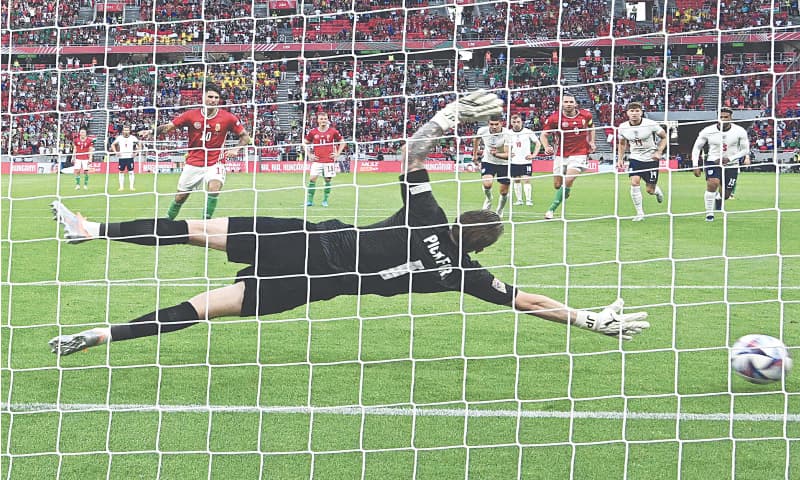 BUDAPEST: Hungary’s Dominik Szoboszlai (C) scores from the penalty spot past England goalkeeper Jordan Pickford during their Nations League match at the Puskas Arena.—AFP BUDAPEST: Hungary’s Dominik Szoboszlai (C) scores from the penalty spot past England goalkeeper Jordan Pickford during their Nations League match at the Puskas Arena.—AFP
