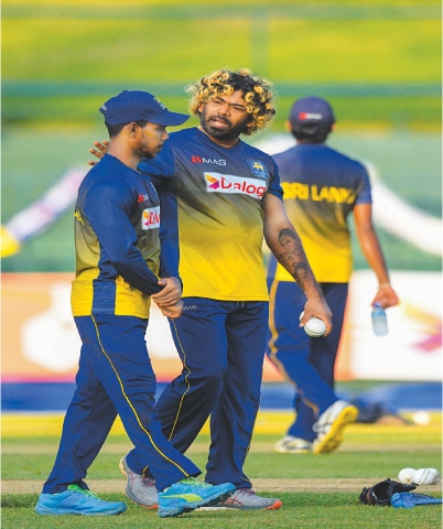 PALLEKELE: Sri Lanka&rsquo;s bowling strategy coach Lasith Malinga (R) speaks with batter Pathum Nissanka during a practice session at the Pallekele International Cricket Stadium on Friday.&mdash;AFP