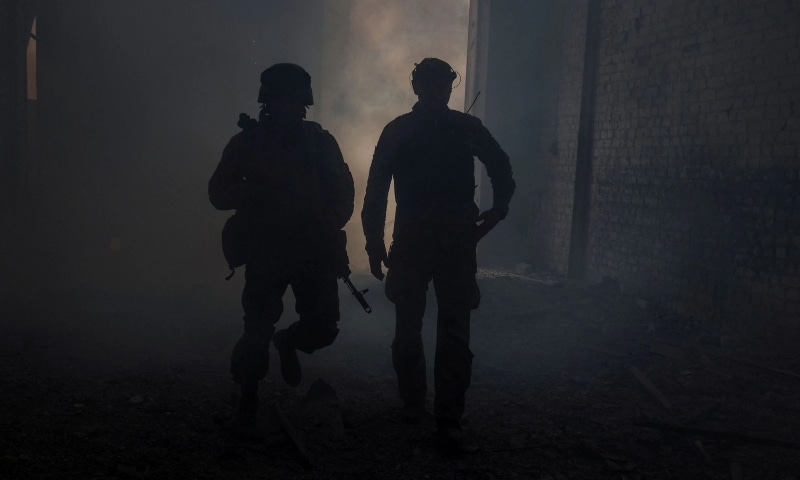 Ukrainian service members walk in the industrial area of the city of Sievierodonetsk, as Russia's attack on Ukraine continues, Ukraine, June 20. — Reuters