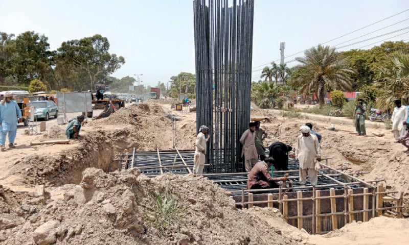 GUJRAT: Construction of piles of the flyover project is underway along the GT Road. — Dawn