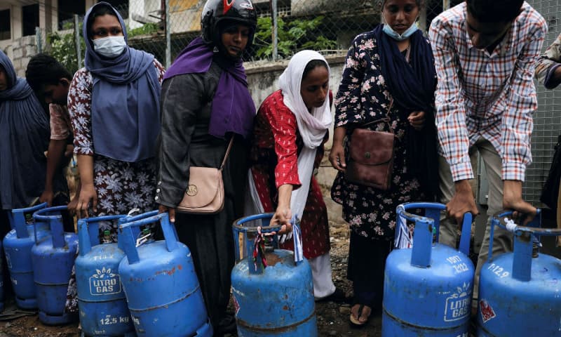 People wait in a line to buy domestic gas tanks near a distributor, amid the country's economic crisis. — Reuters People wait in a line to buy domestic gas tanks near a distributor, amid the country's economic crisis. — Reuters