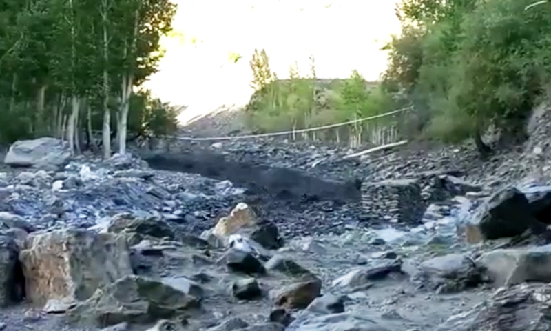 A still of the glacial lake outburst flood crashing through a wooden suspension bridge on Thursday.—DawnNewsTV