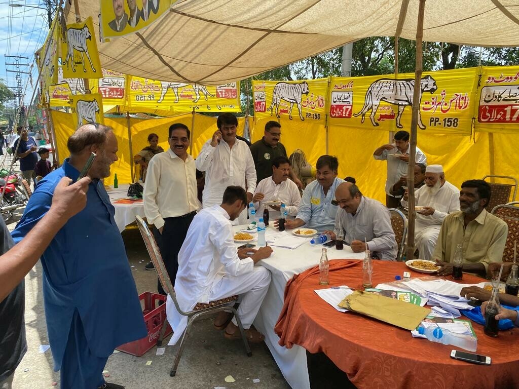 People seated at a PML-N election camp. &mdash;Photo by Omer Hayat
