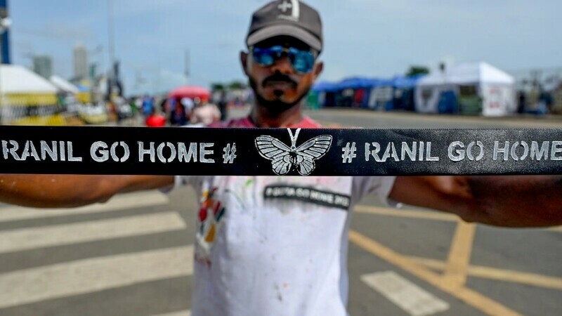 A demonstrator displays a headband with a slogan against interim Sri Lankan President Ranil Wickremesinghe during a demonstration near the Presidential secretariat in Colombo on July 17, 2022. &mdash; AFP