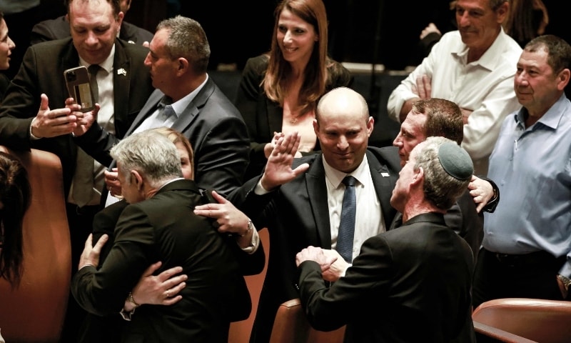 sraeli politicians congratulate Israeli Minister of Foreign Affairs Yair Lapid (L) and outgoing Prime Minister Naftali Bennett, following the dissolution of the parliament, in Jerusalem on June 30. — AFP