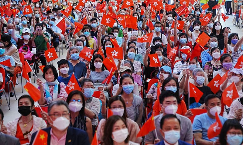 People wave Chinese and Hong Kong flags during a celebration event for the 25th anniversary of Hong Kong's handover to China from Britain, in Hong Kong, China June 26, 2022. — Reuters/File