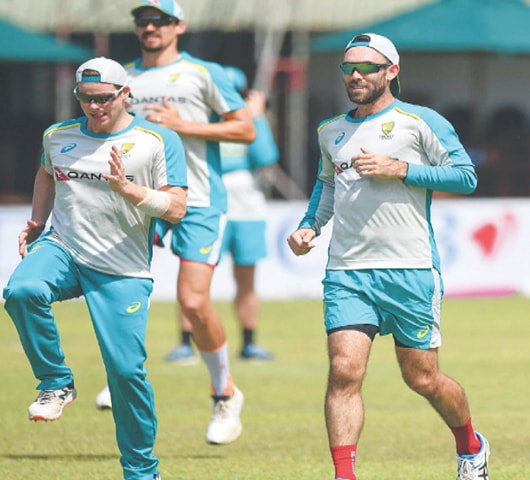 GALLE: Australia’s Glenn Maxwell (R) and Steven Smith warm up during a practice session at the Galle International Cricket Stadium on Wednesday, ahead of the second Test against Sri Lanka.—AFP