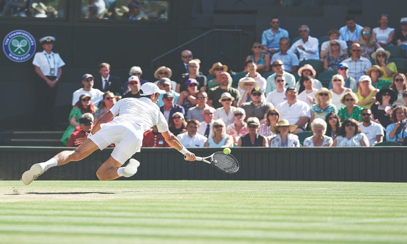 SERBIA’S Novak Djokovic slips as he tries to return a shot against Cameron Norrie of Britain during their Wimbledon semi-final at The All England Tennis Club on Friday.—AFP SERBIA’S Novak Djokovic slips as he tries to return a shot against Cameron Norrie of Britain during their Wimbledon semi-final at The All England Tennis Club on Friday.—AFP