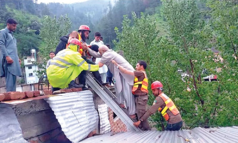 Workers rescue a man after a landslide hit his house in Alpuri, Shangla. — Dawn Workers rescue a man after a landslide hit his house in Alpuri, Shangla. — Dawn