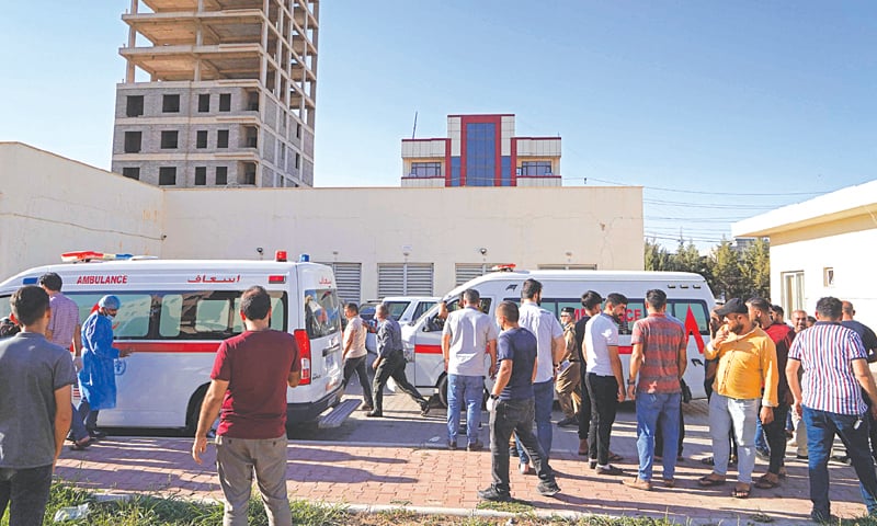 PEOPLE gather outside a hospital following the shelling of Zakho.—AFP