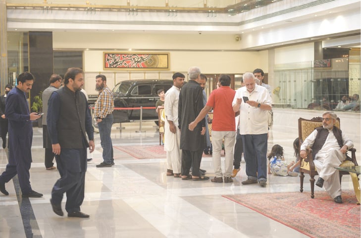 PTI MPAs mill around the lobby of the Pearl Continental Hotel on Thursday, on the eve of the election for the Punjab CM.—Murtaza Ali / White Star