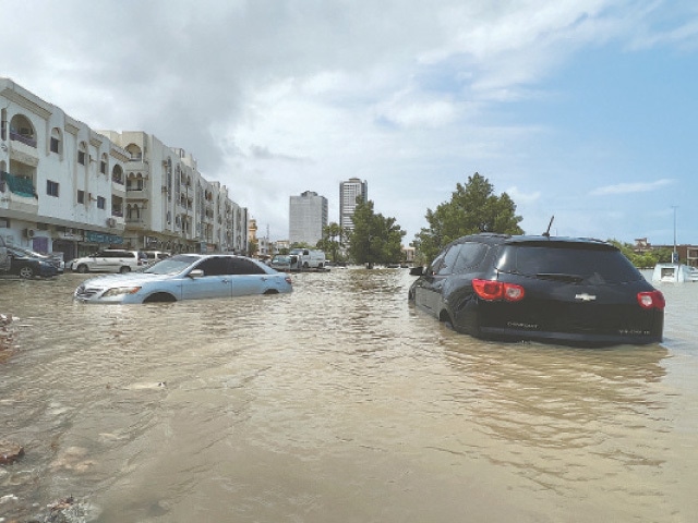 VEHICLES are seen submerged following a day of heavy rain in UAE’s Fujairah area on Thursday. —Reuters / AFP