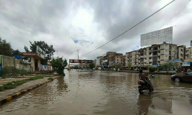 A patch on Karachi’s University Road can be seen as flooded after rain on July 11. — Photo by Azhar Khan