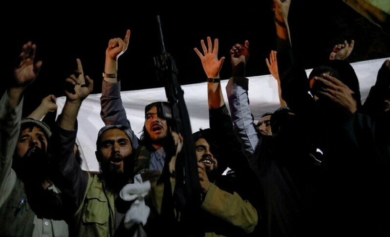 A man holds a gun as Taliban supporters celebrate the first anniversary of the departure of U.S. forces from Afghanistan on a street in Kabul on Tuesday. &mdash; Reuters