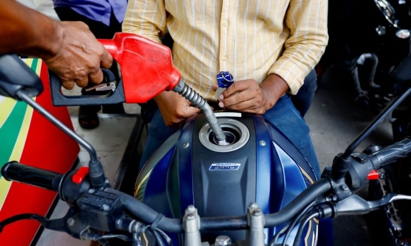 People refuel their motorcycles at a gasoline station after fuel price surge up to fifty percent in Dhaka on August 6. — Reuters