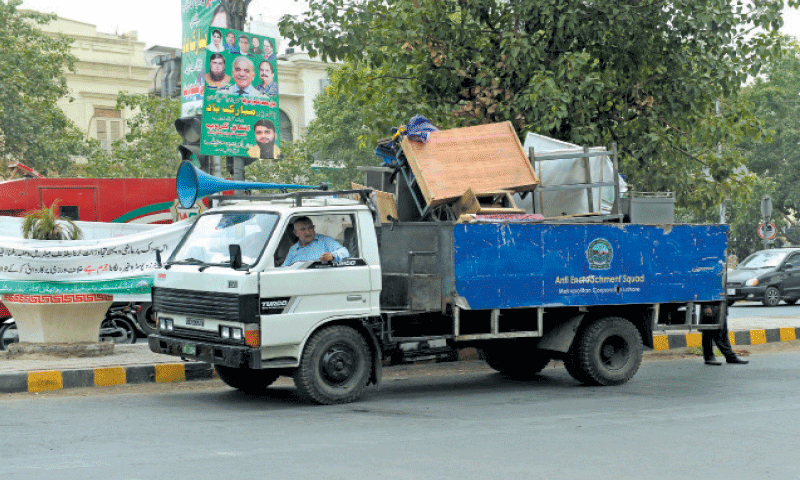 A truck carries seized merchandise. &mdash; White Star