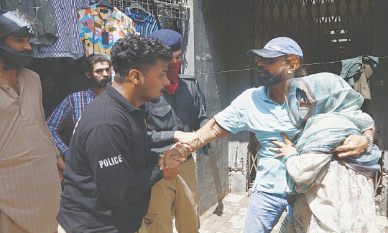 This image shows police arresting a protester. — Dawn