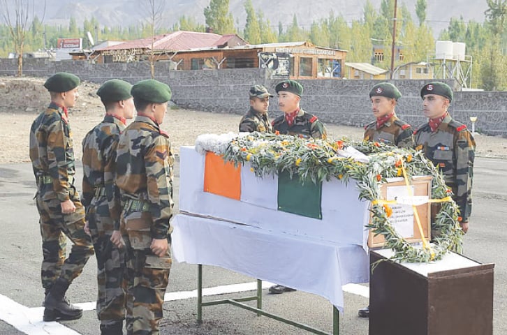 INDIAN soldiers stand in respect next to a coffin with the remains of Chander Shekhar.—AFP