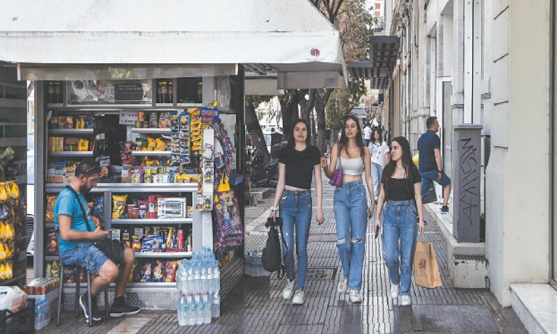 Thessaloniki: Pedestrians walk in a street on Saturday. The EU has ended its fiscal surveillance of Greece imposed in return for bailouts after a crushing debt crisis.&mdash;AFP