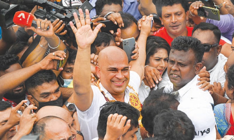OPPOSITION politician Ranjan Ramanayake (centre) waves to supporters after his release from a prison in Colombo. Ramanayake, who was serving a four-year jail term for alleging that a majority of judges in Sri Lanka were corrupt, received a pardon from President Wickremesinghe on Friday.—AFP OPPOSITION politician Ranjan Ramanayake (centre) waves to supporters after his release from a prison in Colombo. Ramanayake, who was serving a four-year jail term for alleging that a majority of judges in Sri Lanka were corrupt, received a pardon from President Wickremesinghe on Friday.—AFP