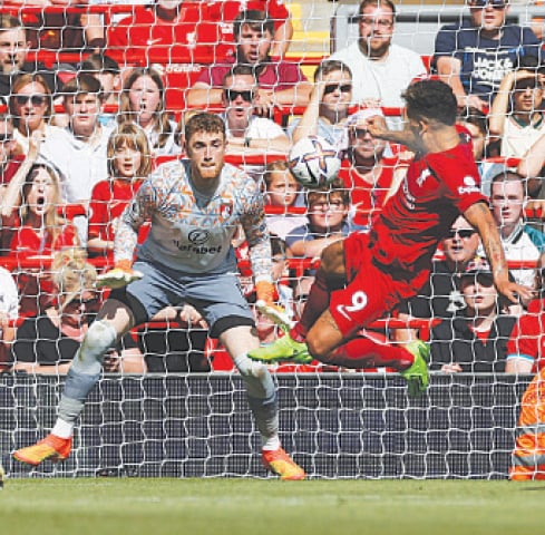LIVERPOOL: Liverpool&rsquo;s Roberto Firmino (R) scores during the Premier League match against Bournemouth at Anfield on Saturday.&mdash;Reuters