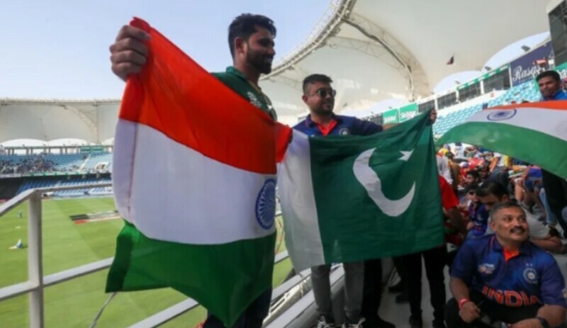 The photo shows fans of India and Pakistan cricket teams posing for a picture together. — AFP.File