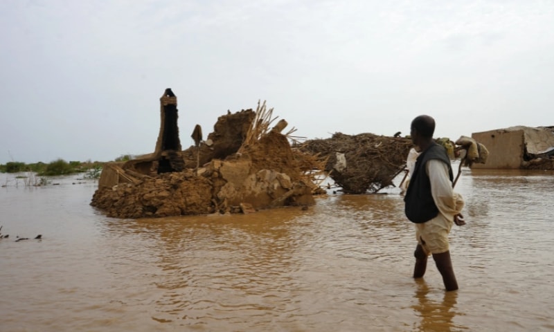 A Sudanese man walks through a flooded area on August 18, 2022 in the eastern state of Kassala, one of the regions in Sudan affected by torrential rains this week. — AFP A Sudanese man walks through a flooded area on August 18, 2022 in the eastern state of Kassala, one of the regions in Sudan affected by torrential rains this week. — AFP