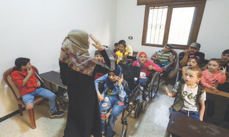 Idlib (Syria): A teacher speaks to a class of children who have been injured or disabled during the war, on the first day of the academic year in this rebel-held northwestern city on Sunday.&mdash;AFP