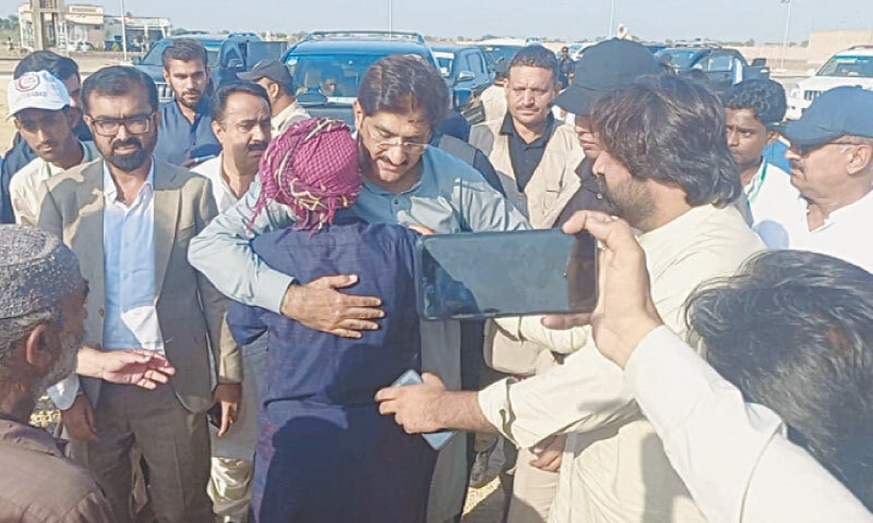 CHIEF Minister Syed Murad Ali Shah comforts a flood victim at a relief camp in Jacobabad on Wednesday.—Dawn