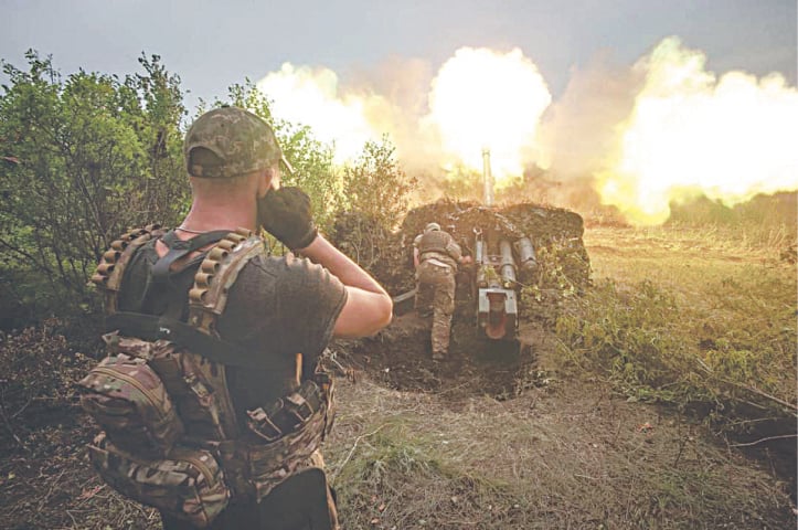 A picture released by Ukraine’s military on Wednesday shows artillerymen firing from a cannon along the frontline at an unknown location.—AFP