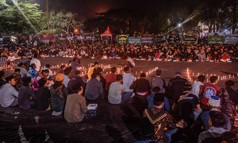 People and football supporters hold candlelight vigil for victims of a stampede at Kanjuruhan stadium in Malang, East Java on October 4, 2022. — AFP People and football supporters hold candlelight vigil for victims of a stampede at Kanjuruhan stadium in Malang, East Java on October 4, 2022. — AFP