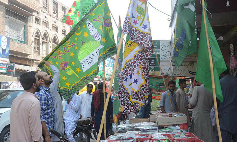 People purchase flags for upcoming Eid Miladun Nabi celebrations on Saturday. &mdash; APP