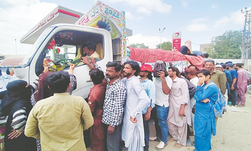 People gather around a truck to buy subsidised flour bags in Nazimabad.—PPI