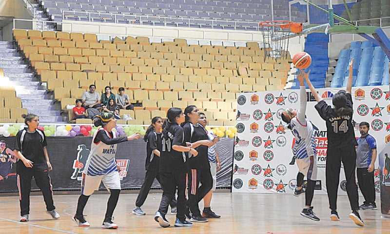 ISLAMABAD: Players in action during the National Women’s Basketball match between Wapda and Islamabad Whites at the Pakistan Sports Complex on Tuesday.—courtesy Federal Basketball Association